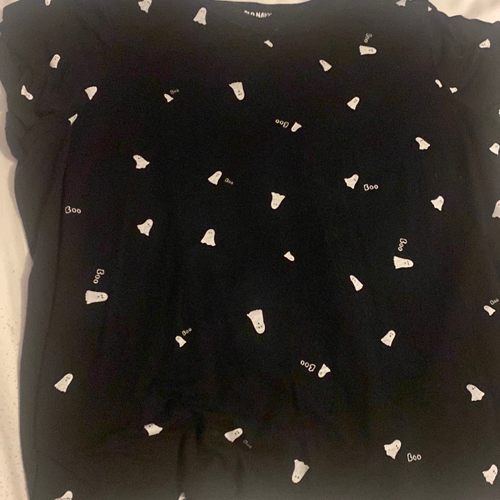 It’s black shirt with ghosts on the shirt and it says boo on the shirt.